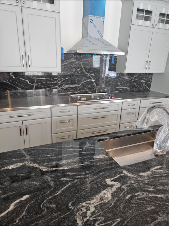 Granite countertop and custom cabinetry installed by Ray Builders